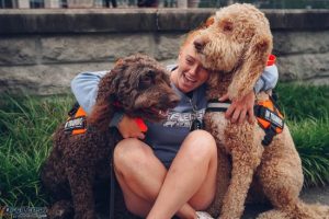 1 Week vs. 2 Week Board and Train: Which Is Right for Your Dog? 2 1 week vs 2 week board and train dogs hugged by trainer