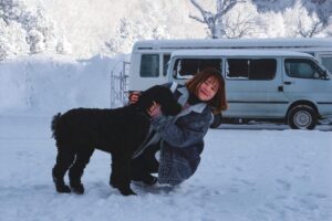 What to Expect After Board and Train Pickup 1 After board and train dog training with black dog in snow